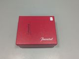 the red box is sitting on the table with its lid open