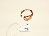 a gold ring with a cat ' s head on it next to a price tag