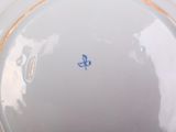 a white plate with a blue and yellow design on it