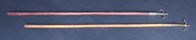 two baseball bats that are next to each other on a table