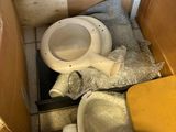 a toilet and a trash can in the corner of a room