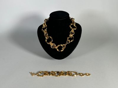 a close up of a necklace and a bracelet on a mannequin