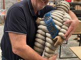 a man that is holding a teddy bear made of doughnuts