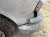 a close up of a car ' s front bumper with mud on it