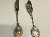 two spoons sitting next to each other on a table