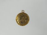 a close up of a gold coin on a white surface