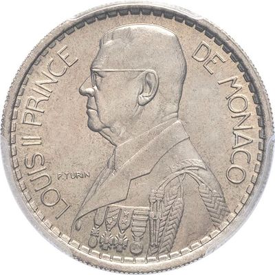 a close up of a coin with a man ' s face on it