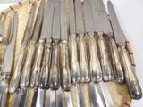 a lot of knives that are sitting on a plate