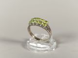 an image of a ring with three green stones