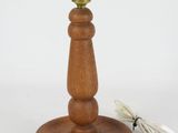 a wooden table lamp that has a cord attached to it