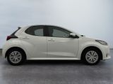 the white car is parked on the concrete floor in the room
