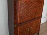 a small chest of drawers in the corner of a room