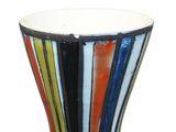 brightly colored vase on a white surface with a white background