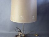an image of a lamp with a deer on it on a wooden base