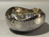 a silver bowl that is sitting on a table