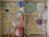 a box full of empty glass bottles and other items