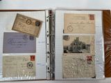 a binder with a lot of old postcards on it