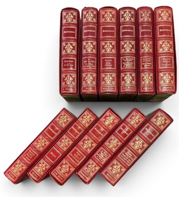 un lot de six livres rouges ornés de motifs dorés