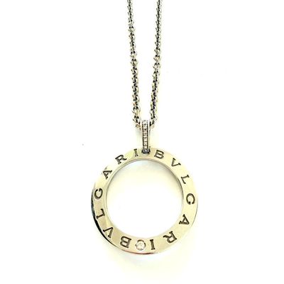 a close up of a necklace on a white surface