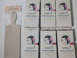 six boîtes de produits capillaires Sibel posées sur une table