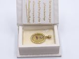 an open box with a gold medal in it on a white surface