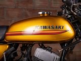 a close up of a motorcycle parked in front of a brick wall