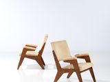 pair of lounge chairs in the style of person, designed by person