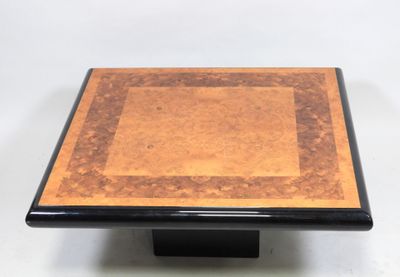 a close up of a square table with a wooden top