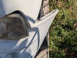a white motorcycle that is sitting on the side of the road
