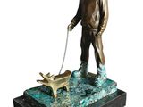bronze statue of a man with a dog on a leash