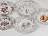 six plates with flowers and fruit on them on a white surface