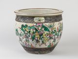 a white vase with a green and pink design on it