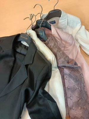 a lot of clothes that are sitting on a table