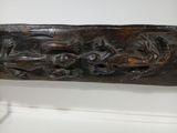 a wooden carving on the wall of a room