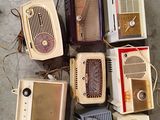 many old radio ' s sitting on the floor next to each other