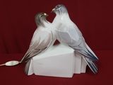two birds that are sitting on top of a box