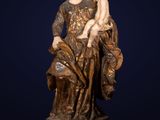 a statue of a woman holding a child on her lap