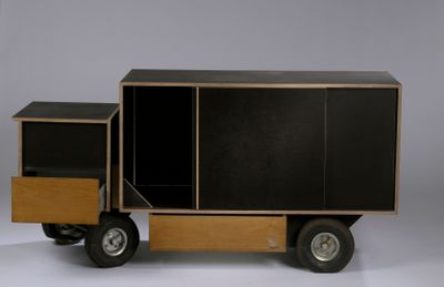 a toy truck that has a cabinet on the back of it