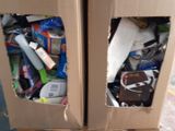 two cardboard boxes that have a lot of stuff inside of them