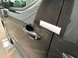 a close up of a car door handle with a sticker on it