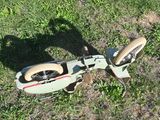 a small bicycle that is sitting in the grass
