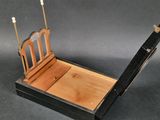 a small wooden bed with a wooden headboard and foot board