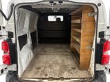 a white van with a wooden door open and shelves in the back of it