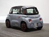 an image of a small electric car on a checkered floor