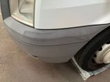 a close up of the front of a car with a denting on it