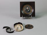 a miniature picture of a man in a suit and tie on a table