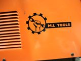 an orange machine with a black and white logo on it