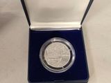 a close up of a silver coin in a case on a table
