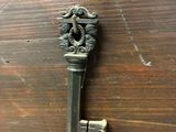an old key on a table with other items on the table