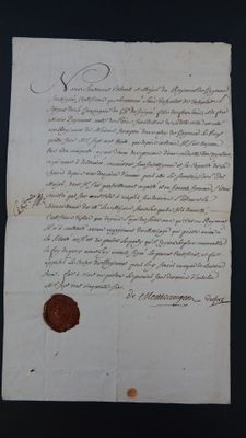 an old document with a wax seal on it sitting on a table